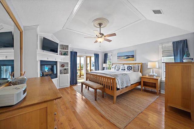 bedroom with ornamental molding, vaulted ceiling, light hardwood / wood-style flooring, and ceiling fan