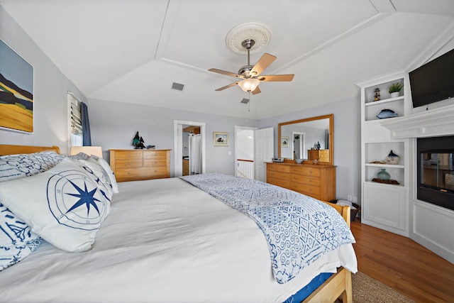 bedroom with lofted ceiling, ceiling fan, and hardwood / wood-style floors