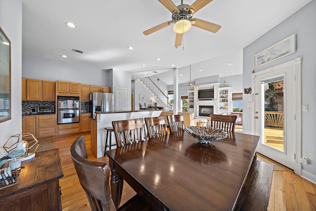 dining area featuring light hardwood / wood-style floors, a wealth of natural light, and ceiling fan