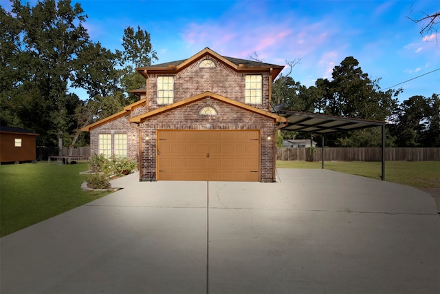 view of property with a carport, a lawn, and a garage