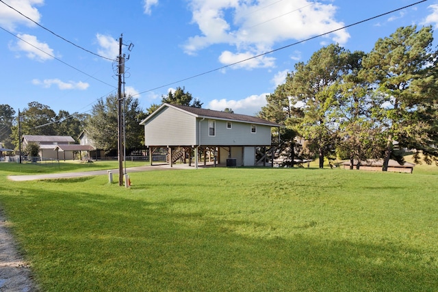 266 Water Ridge Dr, Livingston, TX 77351 - view of grassy yard with stairs, concrete driveway, and central air condition unit