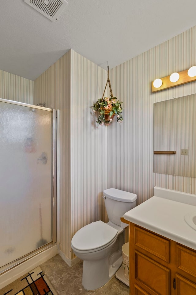 266 Water Ridge Dr, Livingston, TX 77351 - full bathroom featuring wallpapered walls, vanity, a shower stall, and toilet