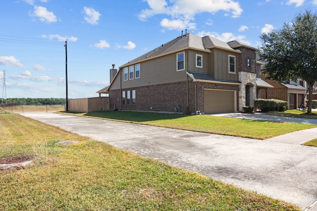 view of front of property featuring a front yard and a garage