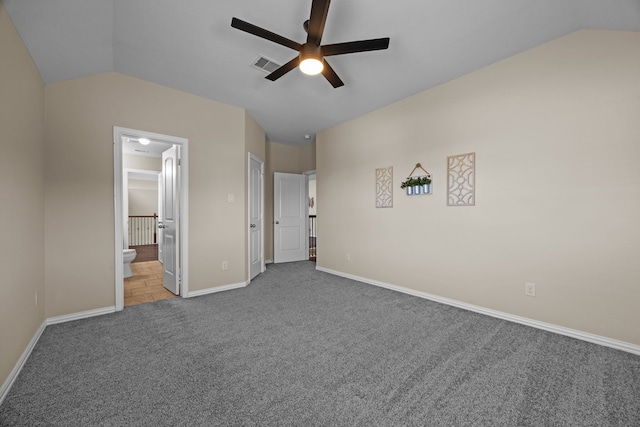 unfurnished bedroom with lofted ceiling, carpet floors, connected bathroom, and ceiling fan