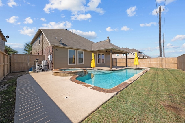 view of swimming pool with an in ground hot tub, a patio, and a lawn