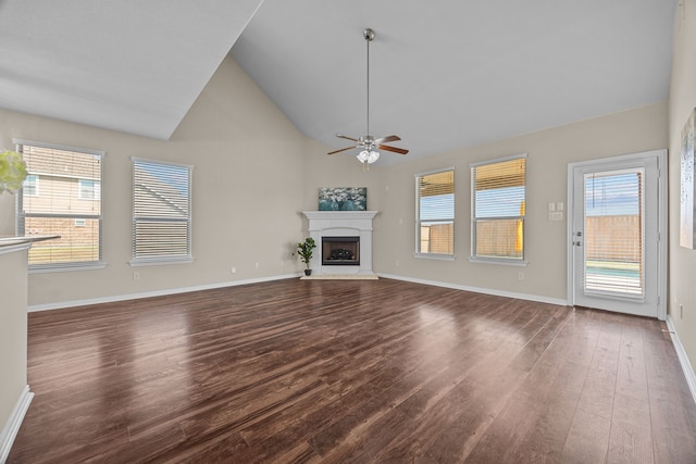 unfurnished living room with ceiling fan, dark hardwood / wood-style floors, and high vaulted ceiling