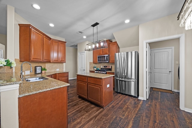 kitchen with a center island, dark hardwood / wood-style floors, sink, pendant lighting, and appliances with stainless steel finishes