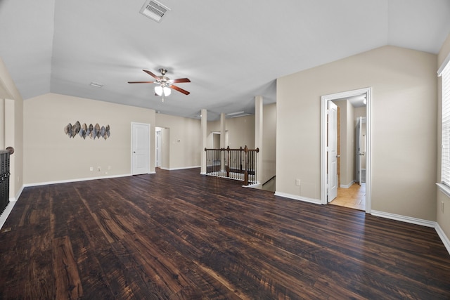 unfurnished living room featuring ceiling fan, vaulted ceiling, and dark wood-type flooring