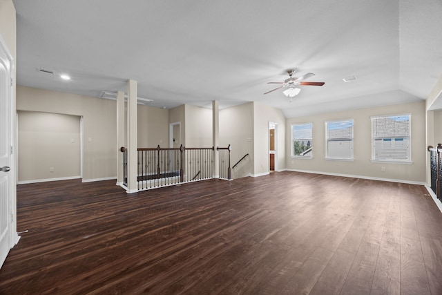 spare room with ceiling fan, vaulted ceiling, and dark wood-type flooring