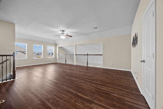 empty room featuring ceiling fan and dark wood-type flooring