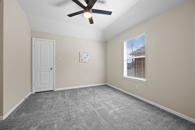 carpeted empty room featuring vaulted ceiling and ceiling fan