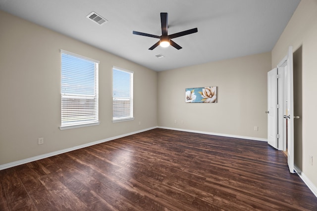 unfurnished room featuring ceiling fan and dark wood-type flooring