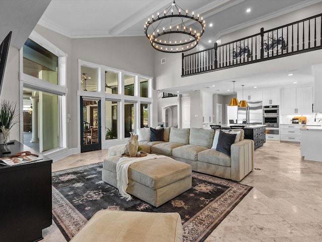 living room featuring a high ceiling, french doors, ornamental molding, a notable chandelier, and beam ceiling