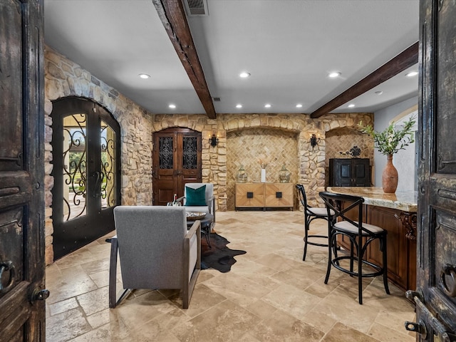 dining room with beam ceiling and french doors