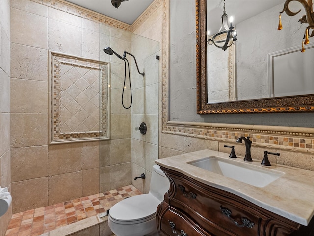 bathroom featuring vanity, toilet, decorative backsplash, and tiled shower