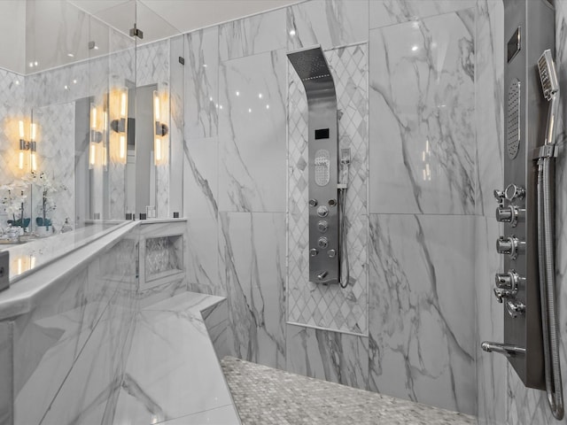 bathroom featuring tile walls and tiled shower