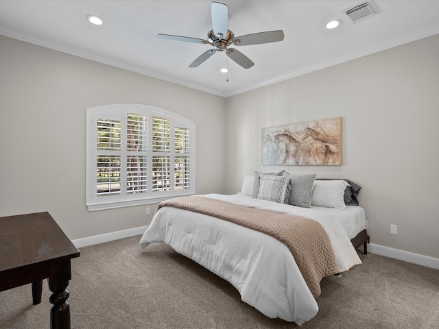 bedroom with ceiling fan, carpet floors, and ornamental molding