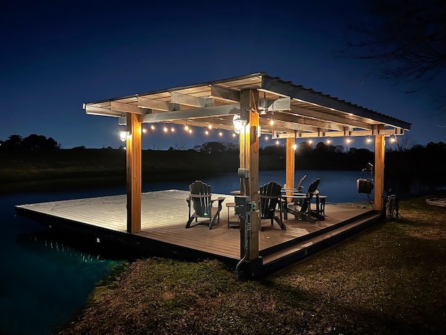 patio at twilight with a pergola and a water view