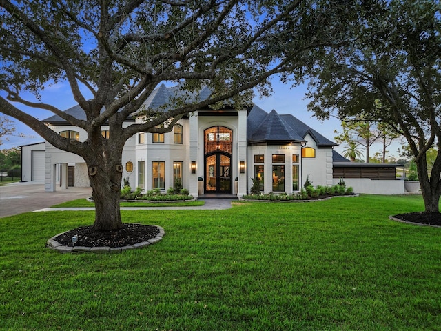 view of front facade with a front yard and french doors