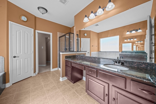 bathroom with vanity, an enclosed shower, decorative backsplash, and tile patterned floors