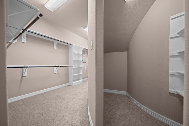 spacious closet featuring carpet flooring and lofted ceiling