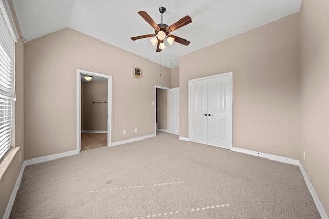 unfurnished bedroom featuring carpet, vaulted ceiling, and ceiling fan