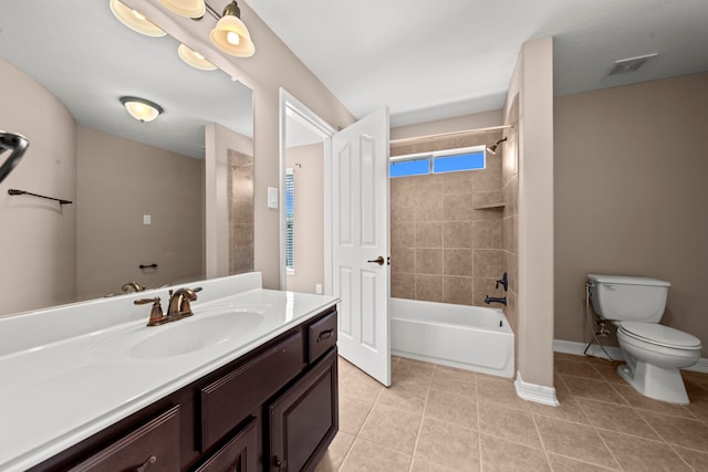 full bathroom with vanity, tiled shower / bath combo, toilet, and tile patterned floors