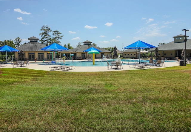 view of swimming pool featuring a yard and a patio