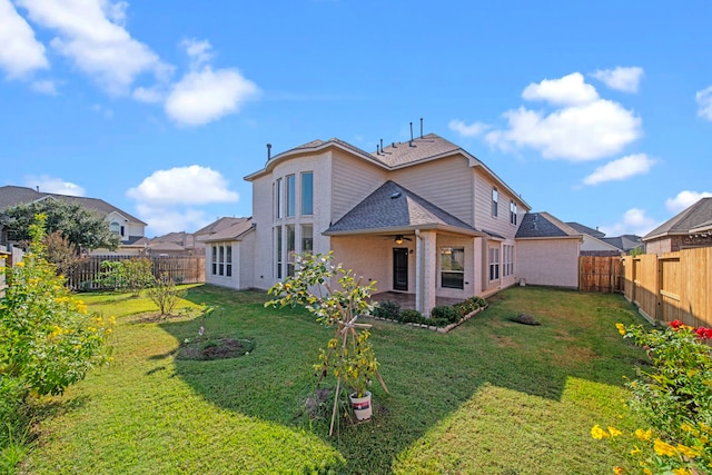 back of house featuring a patio area and a lawn