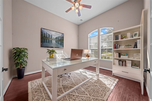 home office with dark wood-type flooring and ceiling fan