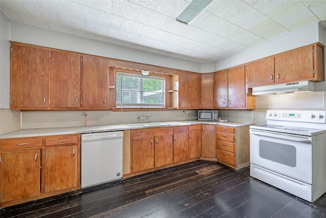 kitchen featuring dark hardwood / wood-style floors, sink, and white appliances