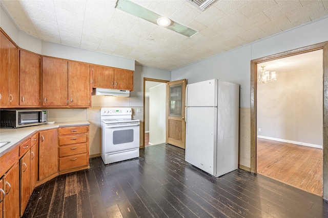 kitchen featuring dark hardwood / wood-style flooring and white appliances