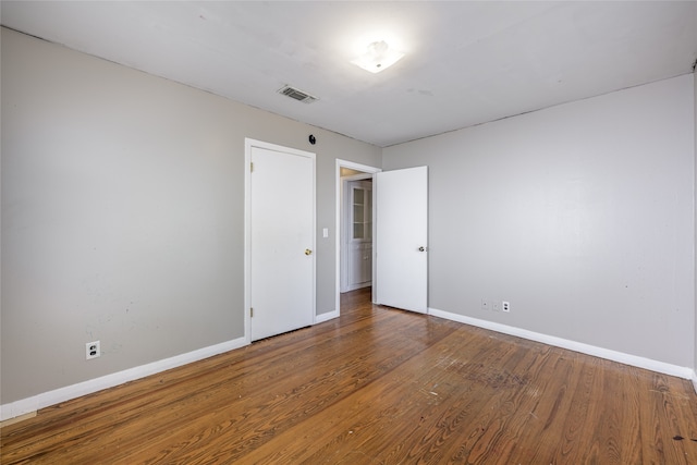 spare room with hardwood / wood-style floors