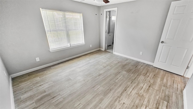 7120 Ave O, Houston, TX 77011 - unfurnished bedroom with baseboards, light wood-style flooring, and ceiling fan