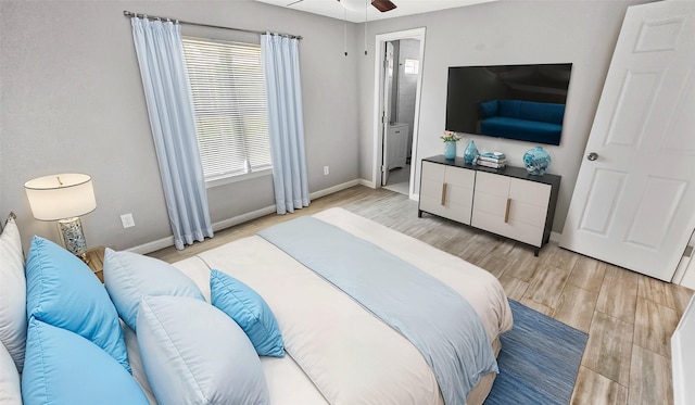 7120 Ave O, Houston, TX 77011 - bedroom featuring baseboards, connected bathroom, and light wood finished floors