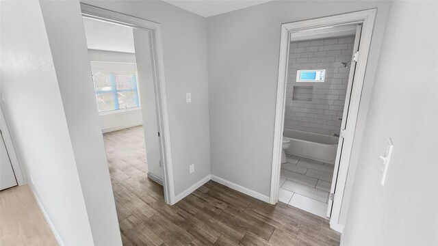 7120 Ave O, Houston, TX 77011 - hallway featuring baseboards and wood finished floors