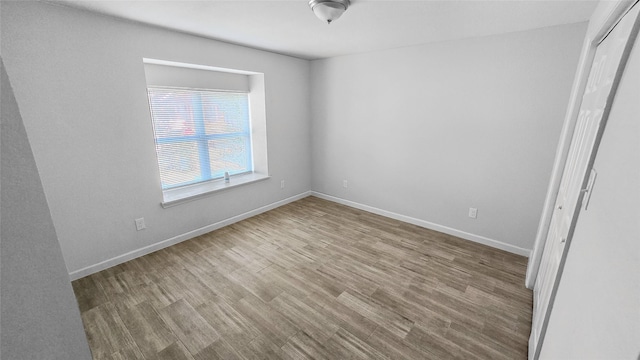 7120 Ave O, Houston, TX 77011 - unfurnished bedroom featuring baseboards, a closet, and wood finished floors