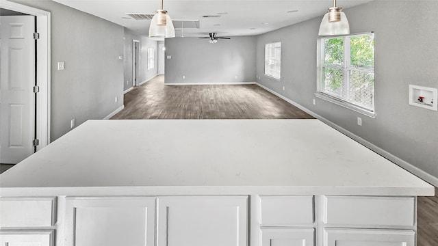 7120 Ave O, Houston, TX 77011 - interior space with baseboards, ceiling fan, wood finished floors, and visible vents