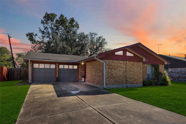 ranch-style house featuring a yard and a garage