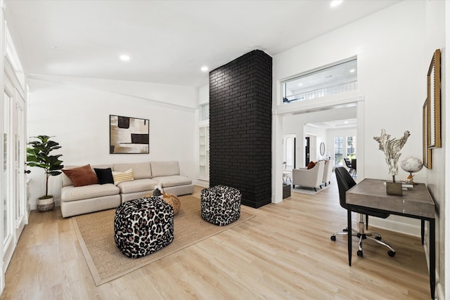 living room with lofted ceiling and light wood-type flooring