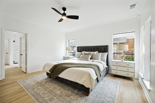 bedroom featuring crown molding, ceiling fan, and light hardwood / wood-style floors