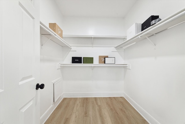 spacious closet featuring light hardwood / wood-style floors