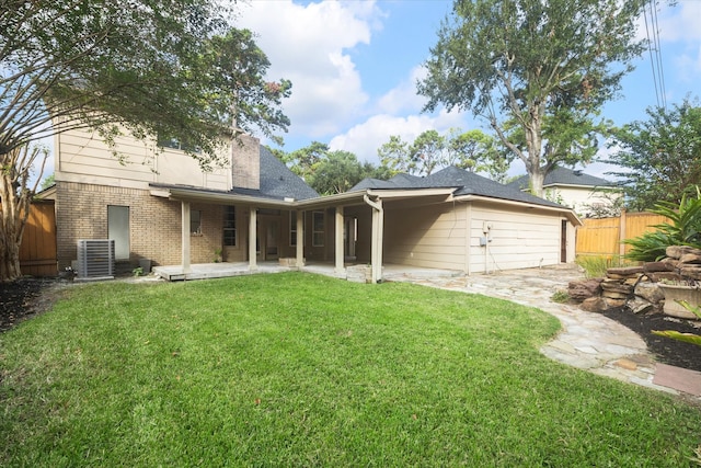 view of front of house featuring central AC, a front yard, and a patio area