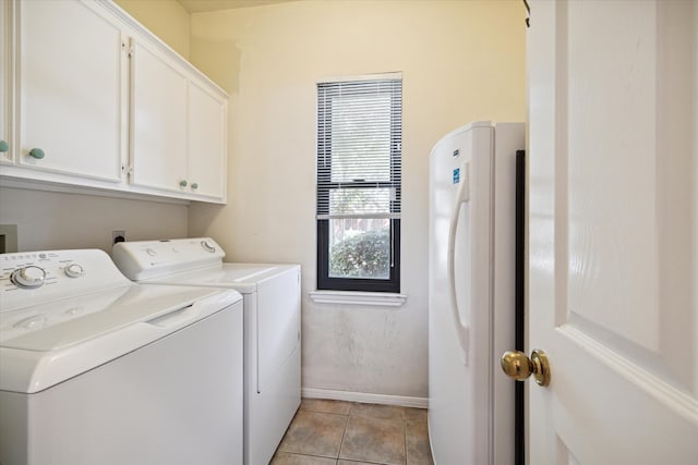 laundry room with separate washer and dryer, cabinets, and light tile patterned floors