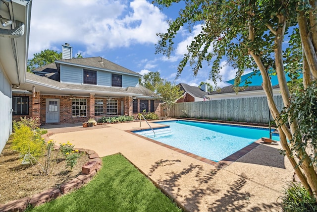 view of swimming pool with a patio