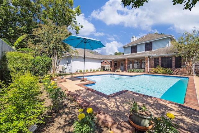 view of swimming pool with a patio