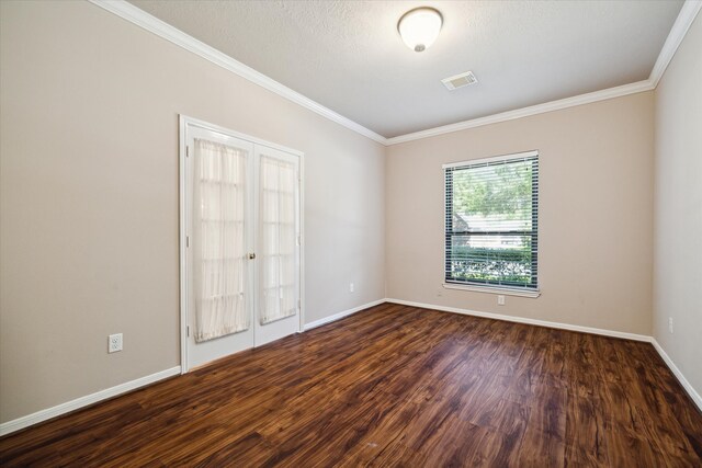 unfurnished room with french doors, dark hardwood / wood-style floors, and ornamental molding