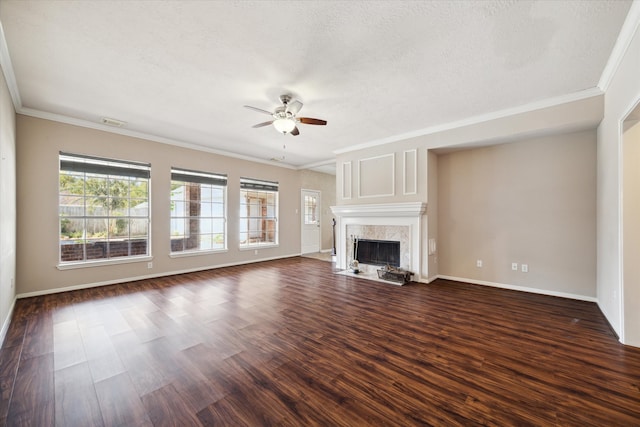 unfurnished living room featuring ceiling fan, a textured ceiling, crown molding, and dark hardwood / wood-style flooring