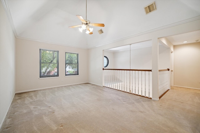 carpeted spare room with ceiling fan, crown molding, and vaulted ceiling