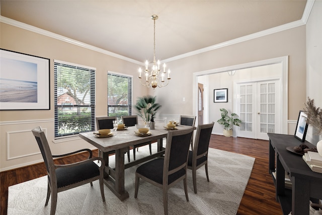 dining area with crown molding, an inviting chandelier, french doors, and dark hardwood / wood-style floors